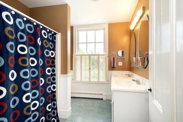 bathroom with baseboard heating, vanity, and tile patterned flooring