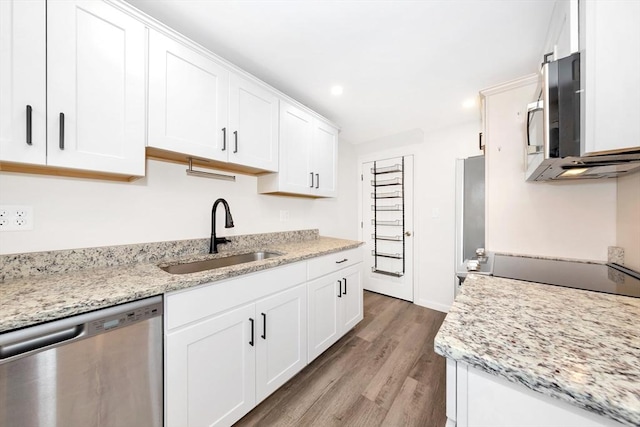 kitchen with white cabinetry, sink, light stone counters, and appliances with stainless steel finishes