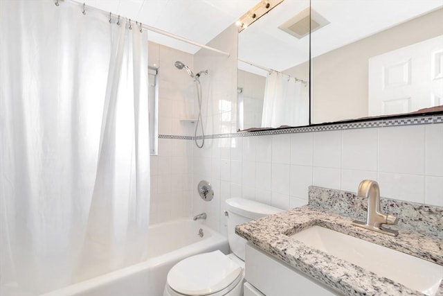 full bathroom featuring tile walls, shower / bath combination with curtain, decorative backsplash, vanity, and toilet