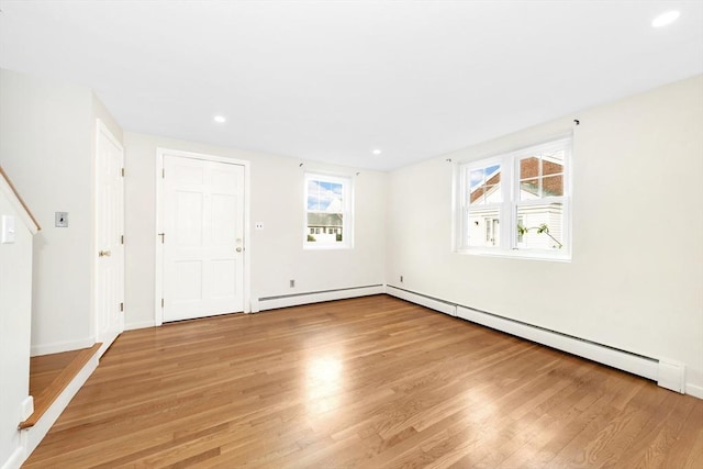 spare room featuring light hardwood / wood-style flooring and a baseboard heating unit