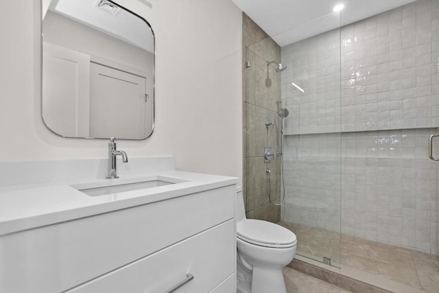 bathroom featuring vanity, toilet, tile patterned floors, and a shower with shower door