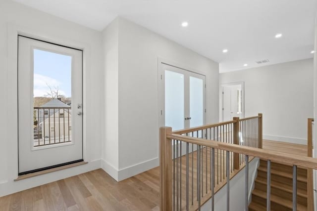 interior space with light wood-type flooring and french doors