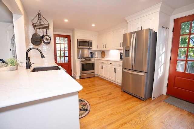 14 N Pleasant St, Dartmouth, MA 02748 - kitchen with stainless steel appliances, light wood-type flooring, white cabinetry, light countertops, and recessed lighting