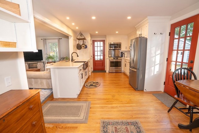 14 N Pleasant St, Dartmouth, MA 02748 - kitchen with stainless steel appliances, light wood-style flooring, a peninsula, plenty of natural light, and recessed lighting