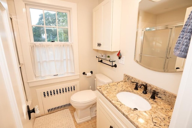 14 N Pleasant St, Dartmouth, MA 02748 - bathroom featuring radiator heating unit, a shower stall, vanity, and tile patterned flooring
