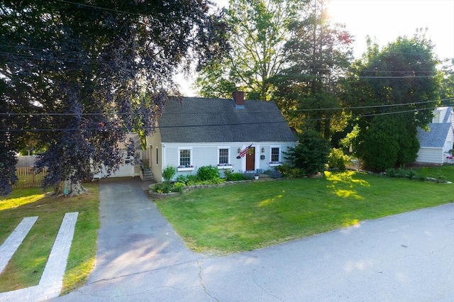 14 N Pleasant St, Dartmouth, MA 02748 - view of front facade with asphalt driveway, a chimney, a front lawn, and a shingled roof