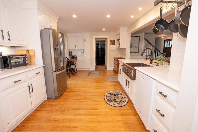 14 N Pleasant St, Dartmouth, MA 02748 - kitchen featuring stainless steel refrigerator with ice dispenser, dishwasher, white cabinetry, light countertops, and light wood-style floors