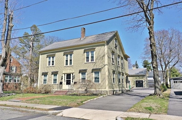 colonial-style house with a chimney
