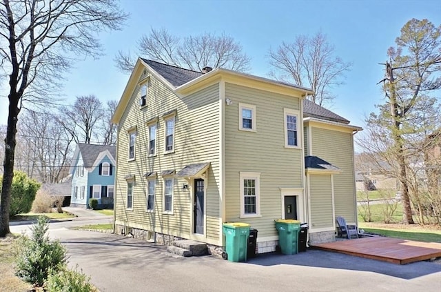 back of property featuring a wooden deck
