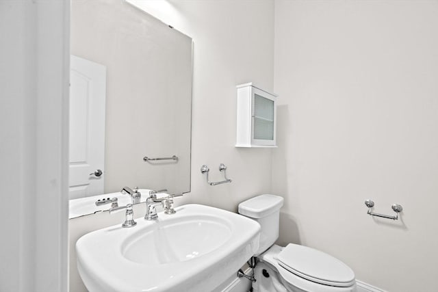 46 Walden Way Unit 46, Milford, MA 01757 - bathroom with toilet, a sink, and baseboards