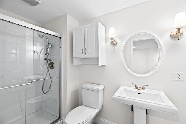 46 Walden Way Unit 46, Milford, MA 01757 - bathroom with toilet, a stall shower, baseboards, and a sink