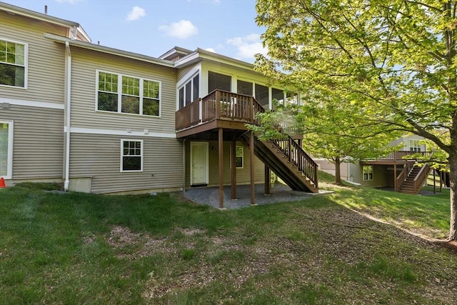 46 Walden Way Unit 46, Milford, MA 01757 - rear view of house featuring stairs, a wooden deck, a sunroom, and a lawn