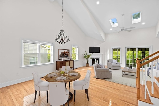 46 Walden Way Unit 46, Milford, MA 01757 - dining room with high vaulted ceiling, hardwood / wood-style floors, plenty of natural light, a fireplace, and baseboards