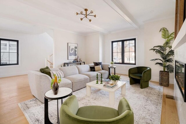 living room featuring crown molding, light hardwood / wood-style flooring, beam ceiling, and an inviting chandelier