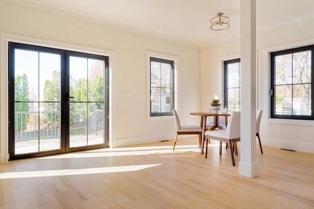 interior space featuring light wood-type flooring and crown molding