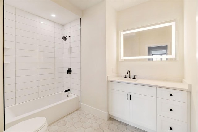 full bathroom with tile patterned floors, tiled shower / bath combo, vanity, and toilet