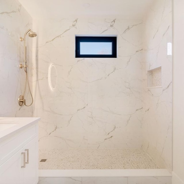 bathroom featuring vanity and a tile shower