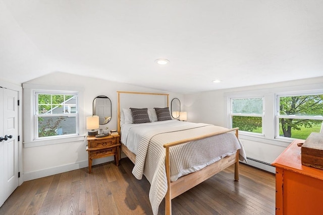 bedroom featuring a baseboard radiator, vaulted ceiling, hardwood / wood-style floors, baseboards, and recessed lighting