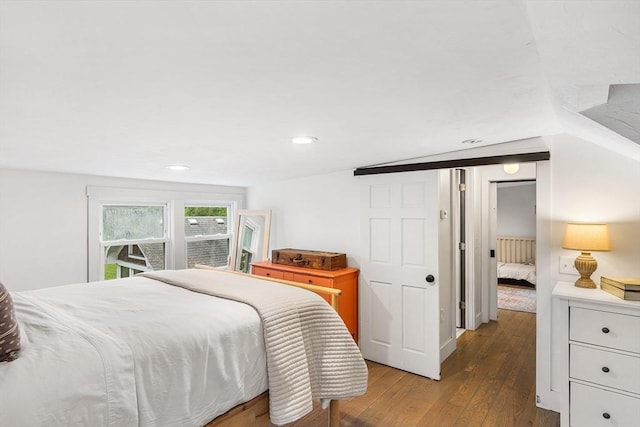 bedroom with hardwood / wood-style floors and recessed lighting