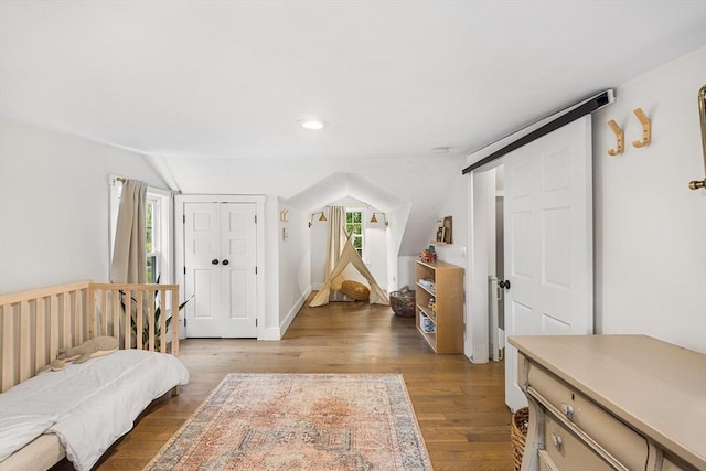bedroom featuring multiple windows, wood finished floors, vaulted ceiling, and recessed lighting