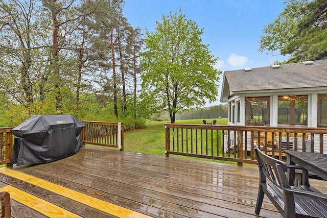 wooden deck featuring a lawn