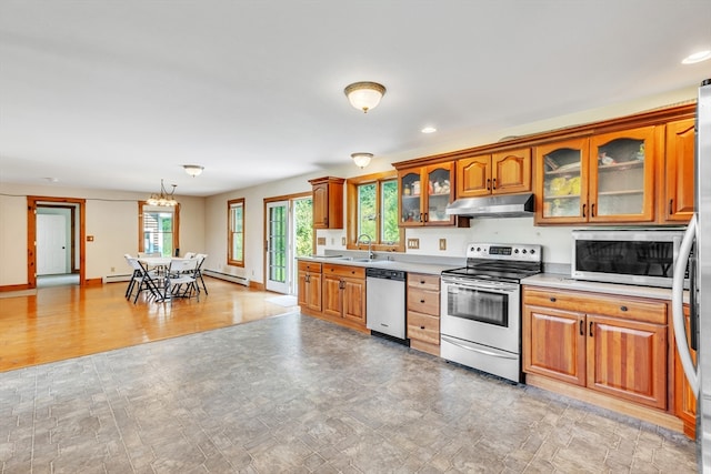 kitchen featuring appliances with stainless steel finishes, light hardwood / wood-style flooring, a chandelier, a baseboard heating unit, and sink