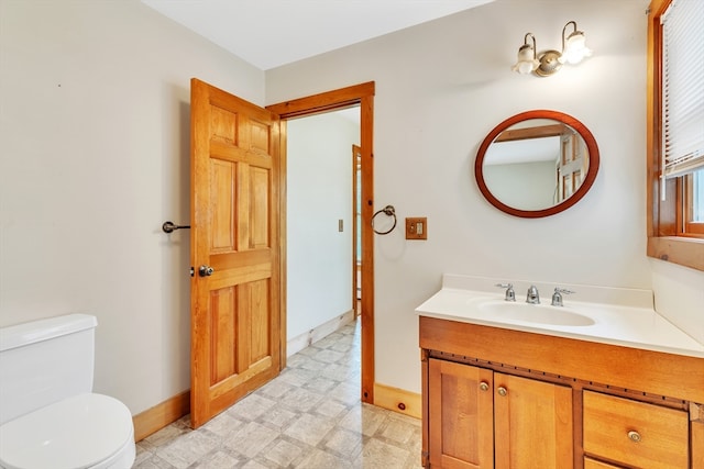 bathroom with tile patterned flooring, toilet, and vanity