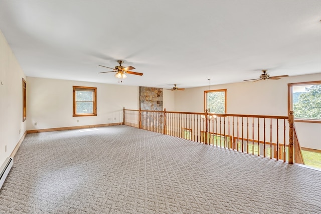 spare room with ceiling fan, a wealth of natural light, and carpet floors