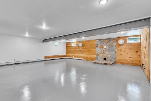 basement featuring wood walls