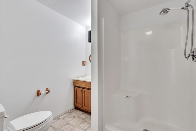 bathroom featuring a shower, toilet, tile patterned flooring, and vanity