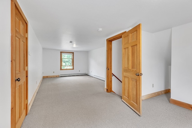 spare room with a baseboard radiator and light colored carpet