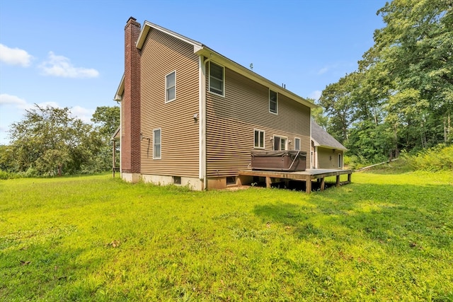 back of house with a lawn and a deck