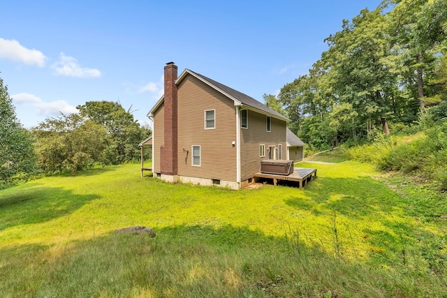 view of side of home with a wooden deck and a yard