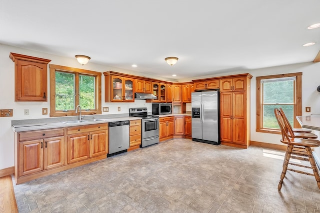 kitchen with sink, light tile patterned floors, and stainless steel appliances