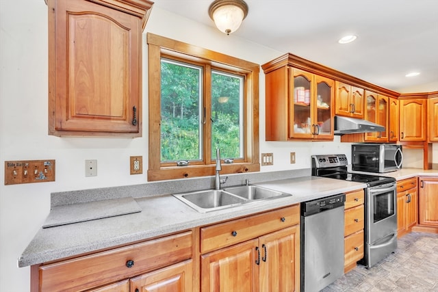 kitchen featuring sink, light tile patterned floors, and stainless steel appliances