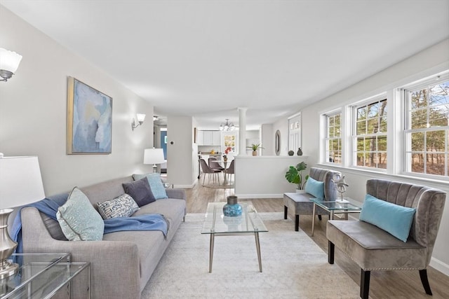 living area with light wood-style flooring and baseboards