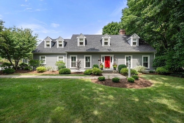 cape cod house featuring a front yard and roof with shingles