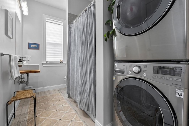148 Winthrop Shore Dr Unit 4, Winthrop, MA 02152 - laundry area featuring stacked washer / drying machine and baseboards