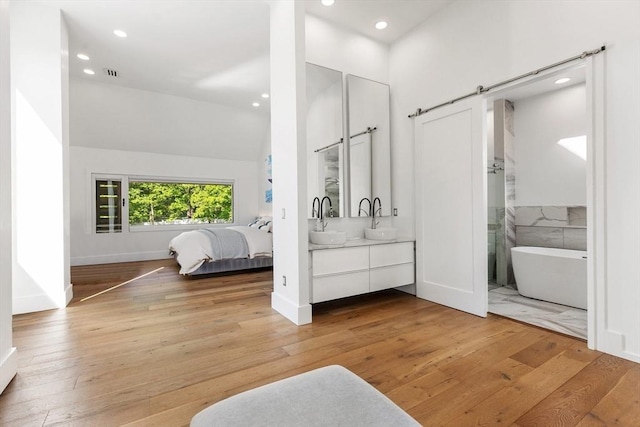 30 Whipple Rd, Lexington, MA 02420 - bathroom featuring a soaking tub, double vanity, wood-type flooring, recessed lighting, and lofted ceiling