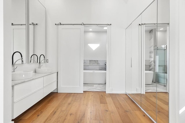30 Whipple Rd, Lexington, MA 02420 - full bath with double vanity, a freestanding bath, and hardwood / wood-style floors