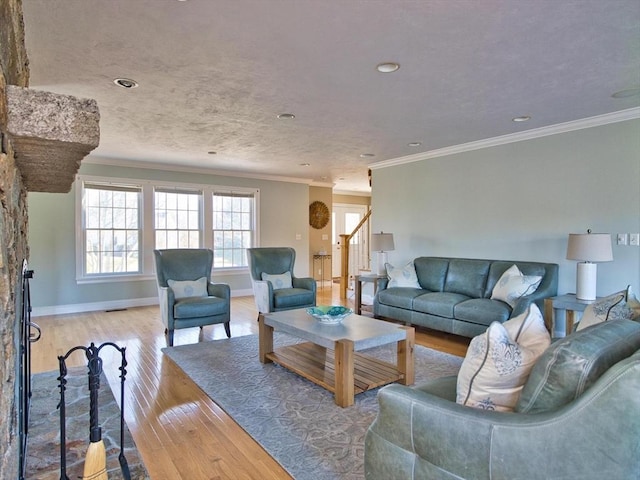 living room featuring ornamental molding and light hardwood / wood-style flooring