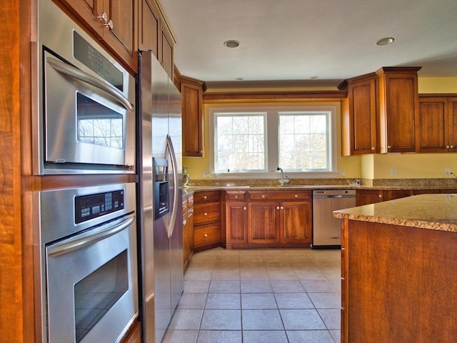 kitchen with sink, light tile patterned floors, and appliances with stainless steel finishes