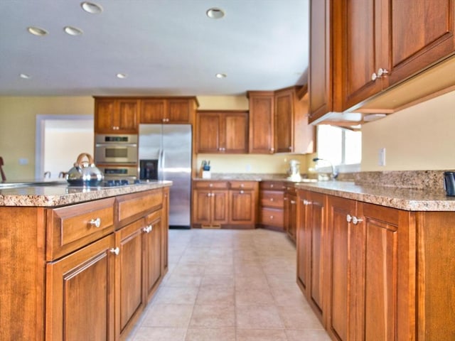 kitchen featuring light tile patterned floors, sink, and appliances with stainless steel finishes