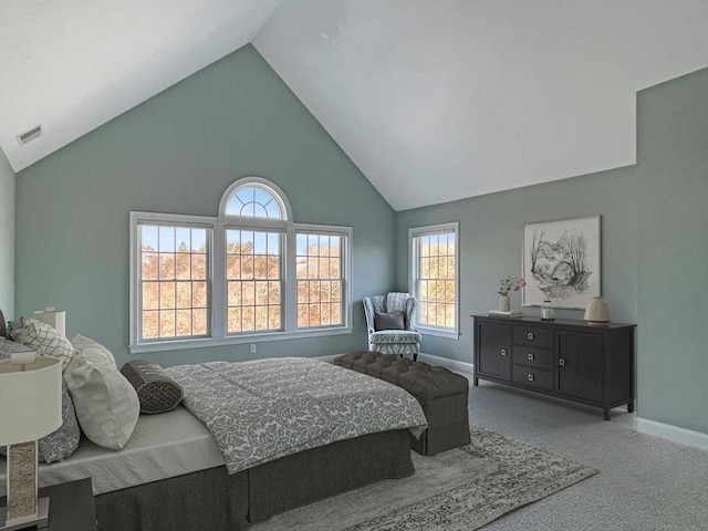 carpeted bedroom featuring high vaulted ceiling