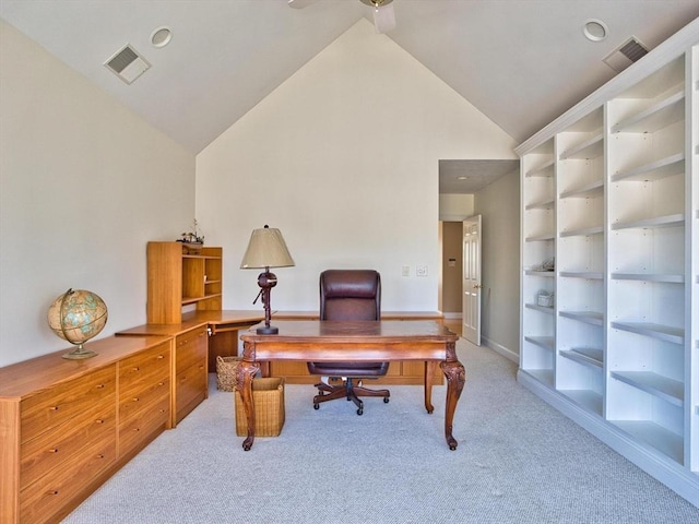 office with carpet flooring, built in shelves, and vaulted ceiling