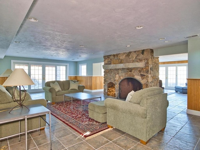 living room with wood walls and a fireplace