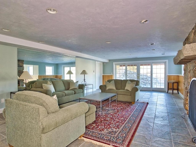 living room with french doors and a textured ceiling