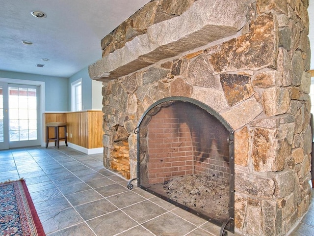 interior details featuring wooden walls and a fireplace