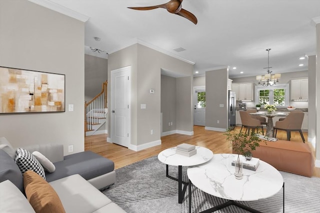 4 Emerald Way Unit 4, Salisbury, MA 01952 - living room with light wood finished floors, stairs, a ceiling fan, crown molding, and a chandelier