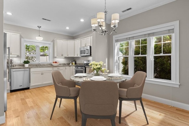 4 Emerald Way Unit 4, Salisbury, MA 01952 - dining space with healthy amount of natural light, ornamental molding, a chandelier, light wood finished floors, and recessed lighting